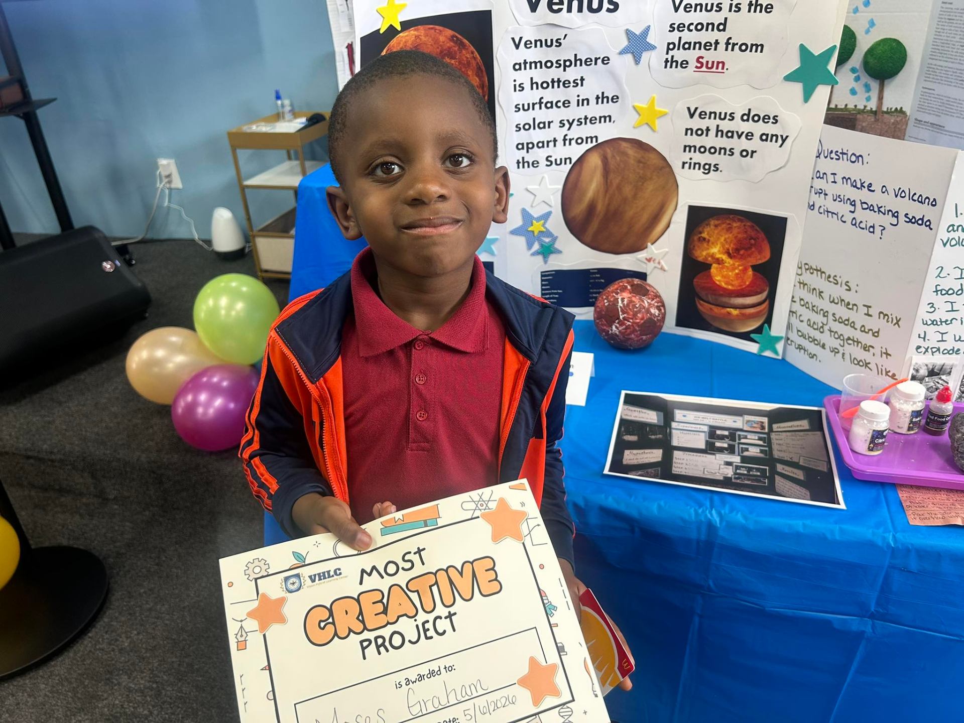 Student holding a Most Creative Project award